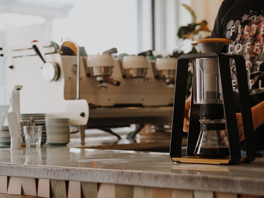 white and silver coffee maker on brown wooden table