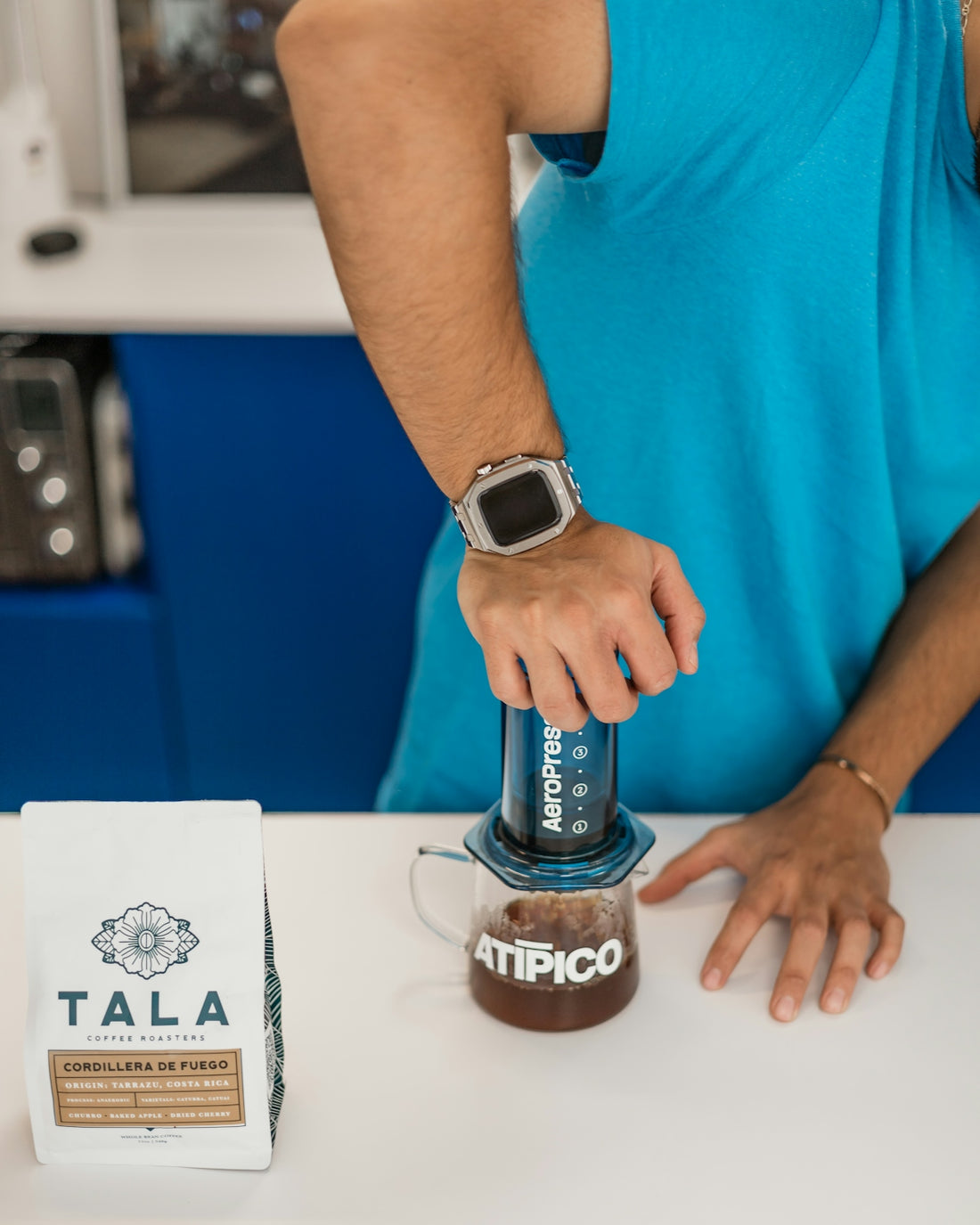 A man pouring a cup of coffee into a blender